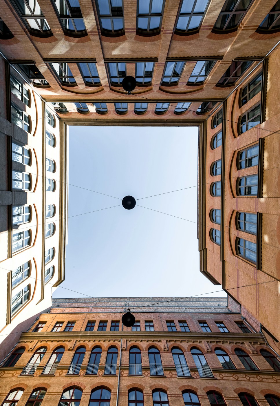 Brick courtyard with a rhythm of windows and a view to the sky