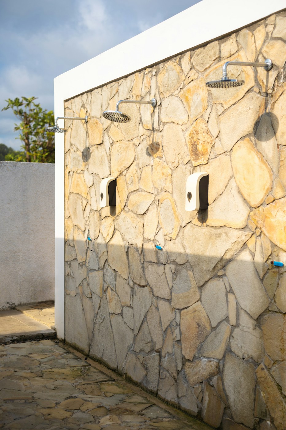 Sunlight on a textured pale stone wall