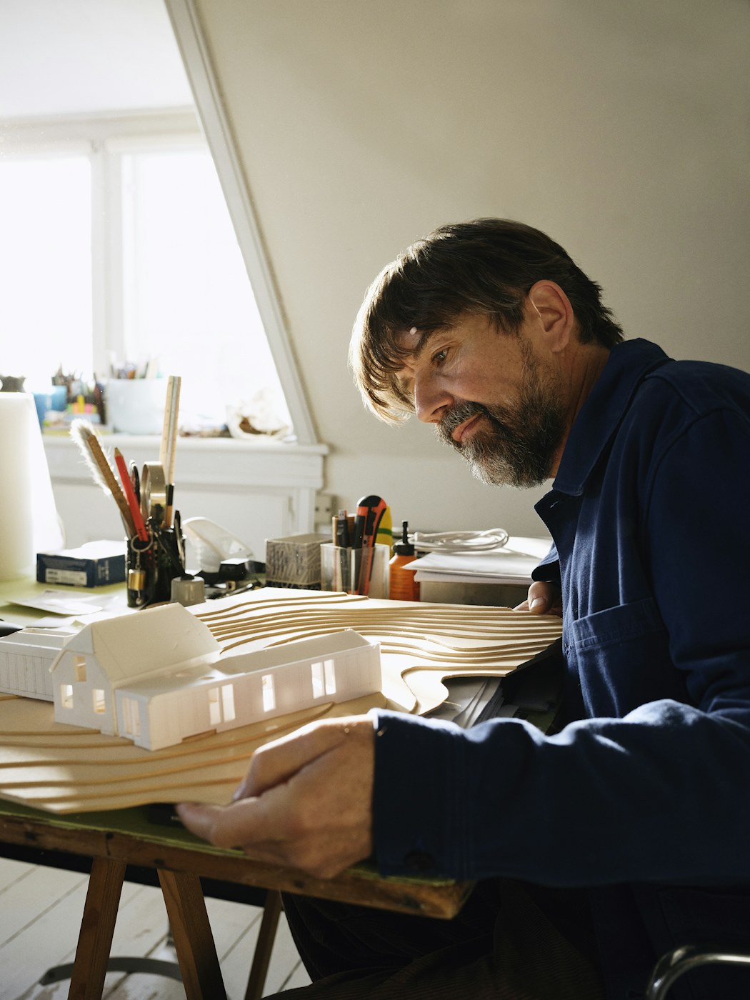 An architect working with a physical architectural model